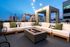 Stylish rooftop lounge area and fire feature at Riva Apartments