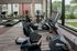 Modern fitness center with state-of-the-art exercise machines and panoramic windows offering scenic views.