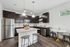 Modern kitchen with sleek stainless steel appliances, dark wood cabinets, and a chic granite island, perfect for entertaining.