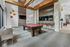 Modern recreation room featuring a stylish pool table, dual flat-screen TVs, and a cozy seating area with contemporary design elements.