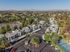 Charming community lush greenery, and nearby pool nestled in a picturesque landscape.