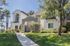 Charming California apartment exterior with modern design, lush greenery, and tall palm trees.