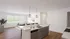 Bright, open-concept living area with sleek kitchen island, modern fixtures, and cozy seating, bathed in natural light.