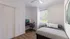 Bright and modern bedroom with a cozy bed, workspace desk and chair by the window, and elegant decor.