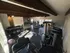 Inviting fitness center with modern exercise equipment, including treadmills, weight racks, and stability balls, bathed in natural light.