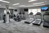 Modern fitness center equipped with treadmills, ellipticals, and strength machines showcasing a bright and inviting workout space.