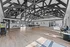 Expansive community room with vaulted ceilings, modern lighting, stylish furnishings, and large windows offering abundant natural light. kids corner, office space for residents, popcorn station, hangout area with tv