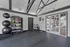 Modern fitness room with sleek design, featuring exercise balls, weights, and ample natural light.