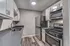 Modern kitchen with sleek stainless steel appliances, elegant gray countertops, and stylish white cabinetry creating a contemporary culinary space.