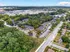 Vibrant aerial view of a lush residential apartment complex surrounded by greenery, offering a tranquil urban living experience.