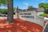 Inviting entrance to Tanglewood Apartments with manicured landscaping and modern signage.