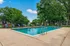 Inviting outdoor swimming pool surrounded by lush greenery and comfortable lounge chairs.