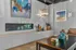 Elegant living room with a modern fireplace, stylish artwork, and ambient lighting, perfect for relaxation and entertaining.