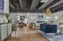 Spacious and stylish living room featuring chic decor, modern furniture, and a luxurious chandelier.