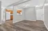 Chic and modern apartment with sleek wood flooring, open-concept layout, and inviting kitchen space.