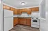 Charming kitchen with wooden cabinetry, modern appliances, and elegant countertops for a stylish and functional cooking space.