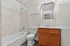Modern bathroom featuring elegant tile, sleek vanity, and ambient lighting for a luxurious feel.