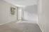 Bright, spacious bedroom boasting a large window for natural light, ample closet space, and soft carpet flooring.