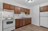 Inviting kitchen with modern white appliances, rich wooden cabinetry, and sleek countertops.