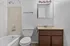 Cozy bathroom with a modern vanity, elegant lighting, and a refreshing bathtub for ultimate relaxation.
