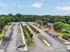 Charming apartment complex nestled among lush greenery with ample parking and scenic views.