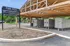 Inviting Park West Apartment Homes entrance featuring a wooden canopy, convenient mailboxes, and clear signage directing to amenities like the leasing office and tennis club.