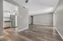 Modern open-concept apartment with sleek hardwood floors, bright kitchen with stainless steel appliances, and expansive living area.