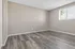 Bright and airy room featuring sleek wood flooring and a large window allowing natural light to illuminate the space.