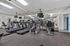Modern fitness center equipped with state-of-the-art treadmills and exercise machines, featuring mirrored walls and bright lighting.