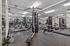 Modern, fully-equipped gym with state-of-the-art fitness machines and mirrored walls for an enhanced workout experience.