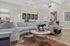 Luxurious living room with modern gray sectional sofa, elegant marble coffee table, and artistic decor, perfect for stylish relaxation.