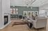 Elegant open-concept living room featuring a cozy fireplace, stylish sectional sofa, and chic decor with a modern chandelier.