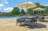 Inviting outdoor pool area with elegant lounge chairs, shady umbrellas, and lush greenery, perfect for relaxation and entertaining.