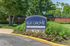 Inviting entrance to Terraces of Elk Grove, featuring a lush garden and welcoming clubhouse leasing center sign.