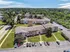 Charming apartment complex nestled in lush greenery, offering spacious living and ample parking.