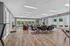 Modern communal lounge with stylish seating, natural light, and a view of the outdoor patio.
