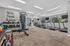Modern fitness center featuring state-of-the-art equipment, including treadmills, weights, and exercise machines, highlighted by motivational artwork.