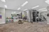 Modern fitness center with gym equipment, featuring kettlebells, dumbbells, weight machines, and motivational decor, perfect for a full workout.