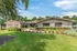 Charming apartment exterior with lush landscaping and vibrant flowerbeds at Woodlands of Crest Hill.