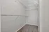 Spacious walk-in closet with modern wire shelving and plush carpeting, ideal for ample storage.