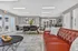 Elegant communal lounge featuring a sleek leather sofa, modern dining area, and contemporary artwork. Ideal for relaxation and socializing in a sophisticated setting.