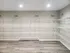 Spacious storage room featuring sleek metal shelving and modern lighting, perfect for organizing your belongings.