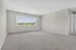 Bright and spacious living area with large window and air conditioning, perfect for tranquil living.