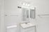 Sleek and modern bathroom with ample counter space, elegant lighting, and minimalist fixtures.