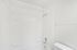 Pristine white bathroom featuring a sleek bathtub and modern fixtures for a refreshing oasis.