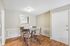 Charming dining area with a glass table, stylish chairs, and elegant wood flooring, perfect for cozy gatherings.
