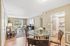Inviting apartment interior showcasing an elegant open-plan living and dining area, featuring stylish furniture and abundant natural light.