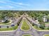 Aerial view of a lush apartment complex featuring well-maintained landscaping, abundant parking, and a serene residential atmosphere.