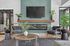 Chic modern living room featuring a sleek wall-mounted TV, elegant fireplace, and stylish velvet chairs with lush greenery accents.