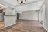 Bright and inviting open-concept living area with modern flooring, ample natural light, and sleek kitchen bar design.